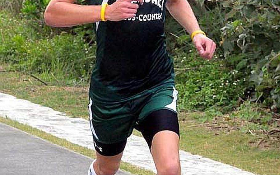 Kubasaki Dragons freshman Erik Armes races for the finish during Wednesday's Okinawa Activities Council district cross-country finals at Zanpa Misaki, Okinawa. Armes won in 16 minutes, 47 seconds, his best time of the season. Kubasaki won the girls and overall meet titles for the first time in 10 years.