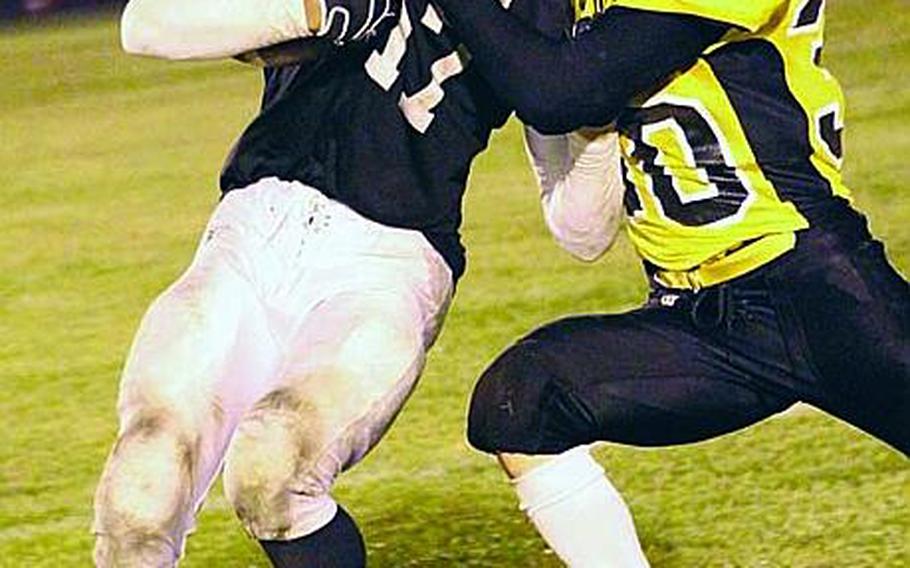 Zama American ballcarrier Mitchell Harrison gets tackled by American School In Japan's Haru Kent during Friday's Kanto Plain Association of Secondary Schools football game at Naval Air Facility Atsugi, Japan. ASIJ won 43-24.