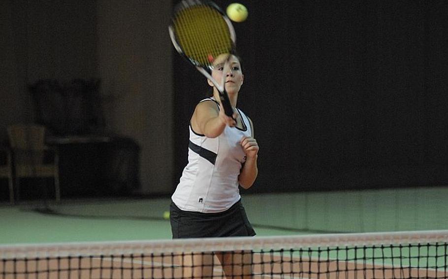 SHAPE senior Selena Suparman smashes the ball over the net Friday during girls doubles action of the European Tennis Championships.