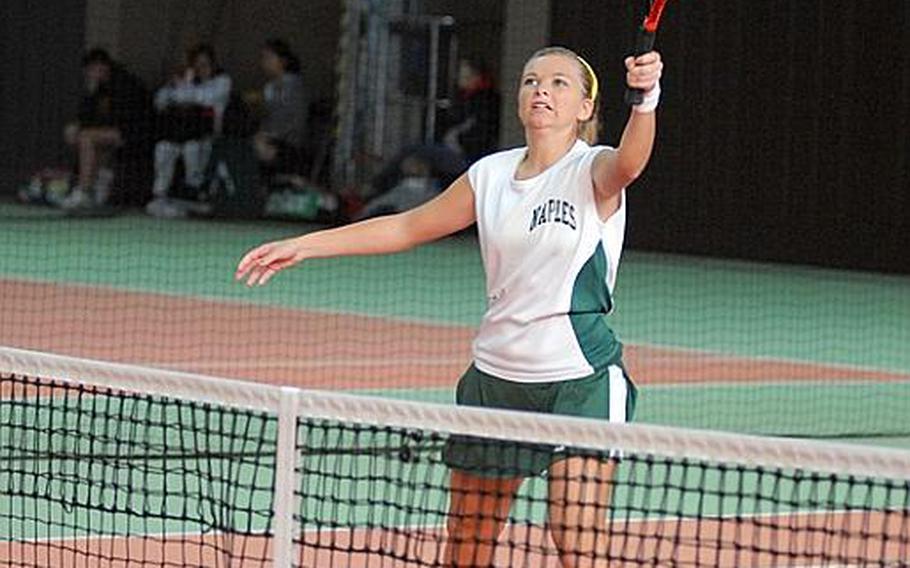 Naples senior Stacia Block reaches up to make contact during a girls doubles match at the 2011 DODDS-Europe tennis championships.