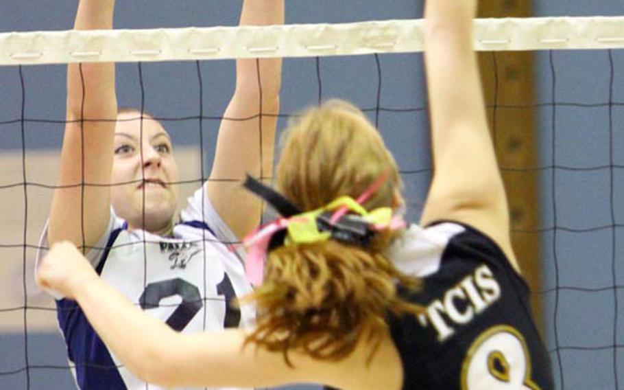 Seoul American's Tammy Garman goes up to block a spike by Taejon Christian International's Becca Roberts during Saturday's championship match in the Korean-American Interscholastic Activities Conference Girls Division I Volleyball Tournament at Falcon Gym, Seoul American High School, South Post, Yongsan Garrison, South Korea. The Falcons won in four sets, giving them the KAIAC regular-season and tournament titles in coach Lori Rogers' first season.