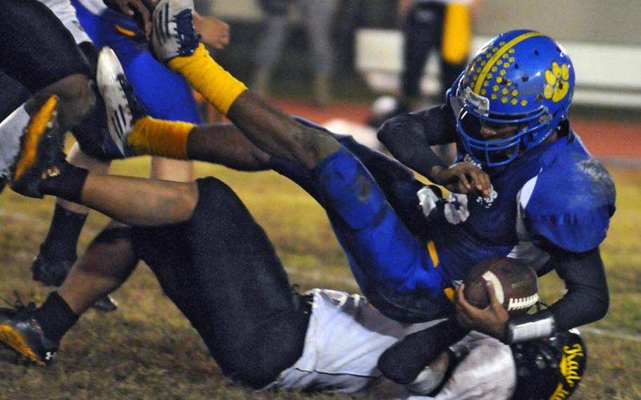 Yokota quarterback Stanley Speed is brought down by Kadena's Gage Bongo during Saturday's Far East High School Division I football semifinal game at Yokota High School, Japan. Yokota won 42-6 and will host Kubasaki in the D-I title game on Nov. 12.