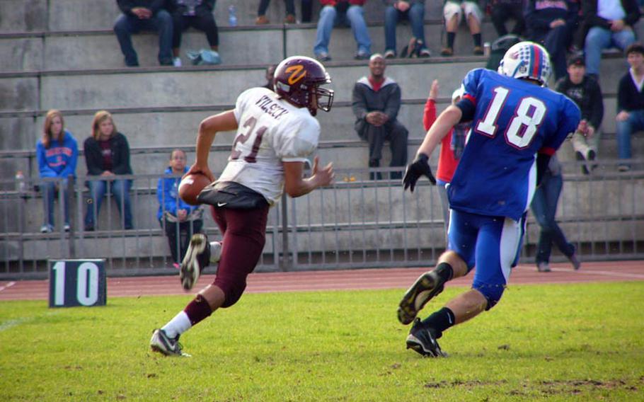 Vilseck quarterback Daniel Arroyo races Ramstein defender Justin Dickey to the corner during the Royals' 24-21 victory over the Falcons in Saturday's Euroopean Division I semifinal game at Ramstein.