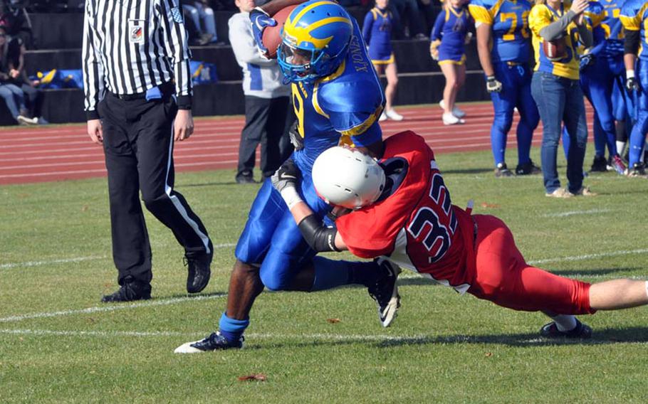 Ansbach senior runningback Xavier Jones rushes downfield Saturday as ISB defender Matias Bifani attempts the tackle. Jones rushed 27 times for 175 yards and a touchdown in the Cougars' 26-12 semifinal win over the visiting Raiders. 