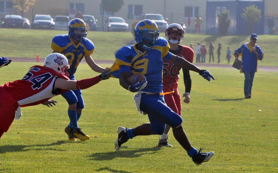 Ansbach senior running back Xavier Jones rushes downfield Saturday as an ISB defender attempts the tackle. Jones rushed 27 times for 175 yards and a touchdown in the Cougars' 26-12 semifinal win over the visiting Raiders.'