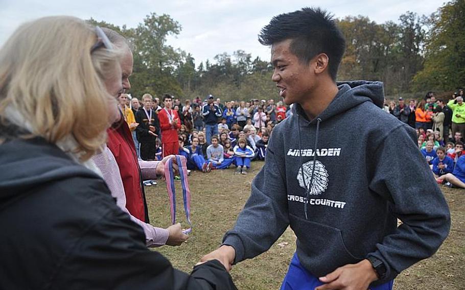 Wiesbaden senior Ryan Fisico is awarded the gold medal for finishing first among the boys at the 2011 DODDS-Europe Cross Country championships Saturday at the Tompkins Barracks training area in the Heidelberg suburb of Schwetzingen, Germany.