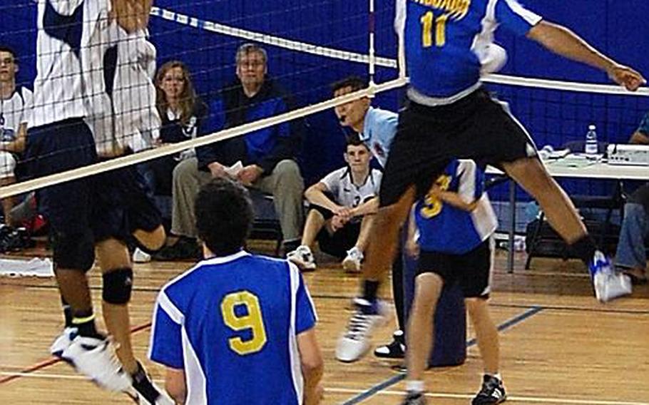 Senior Chris McKissick rises for a kill try during a recent match at Sigonella, Italy. Also involved in the play are Darrion Sands and Austin Bay (behind McKissick).