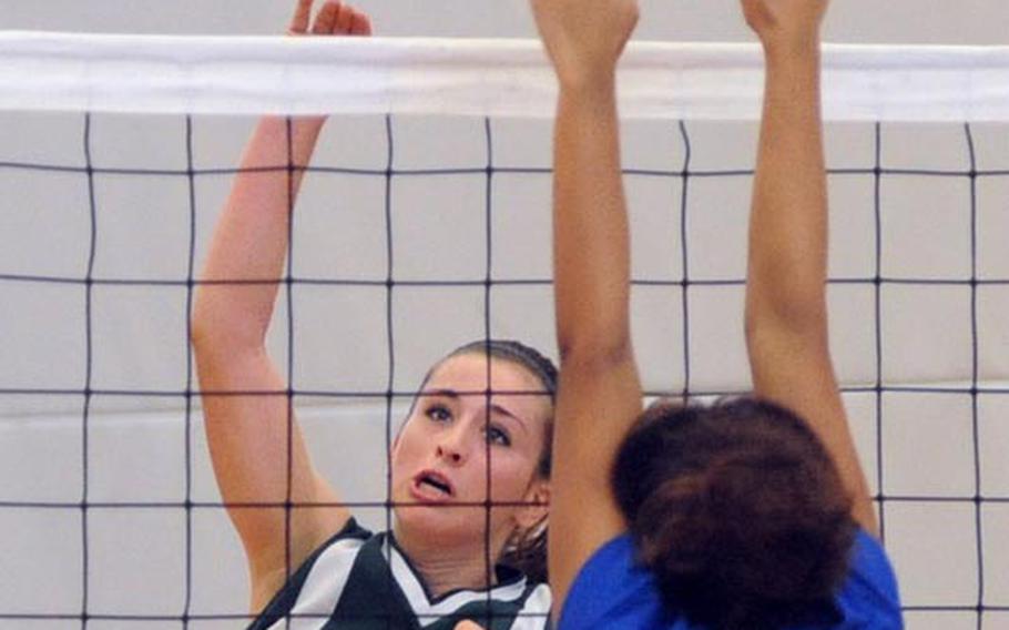 Jackie Lund of Naples knocks the ball over the net against Ansbach's Akira James in their opening day Division II match at the DODDS-Europe volleyball finals on Thursday. Naples won 25-15, 25-23.