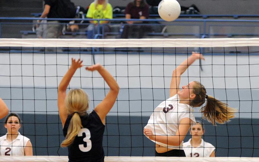 AFNORTH's Rylee McHinney, right, goes up for a ball as Milan's Julia Soete attempts a block. AFNORTH defeated Milan in a Division II game in opening day action at the DODDS-Europe volleyball finals 25-13, 23-25, 25-6.