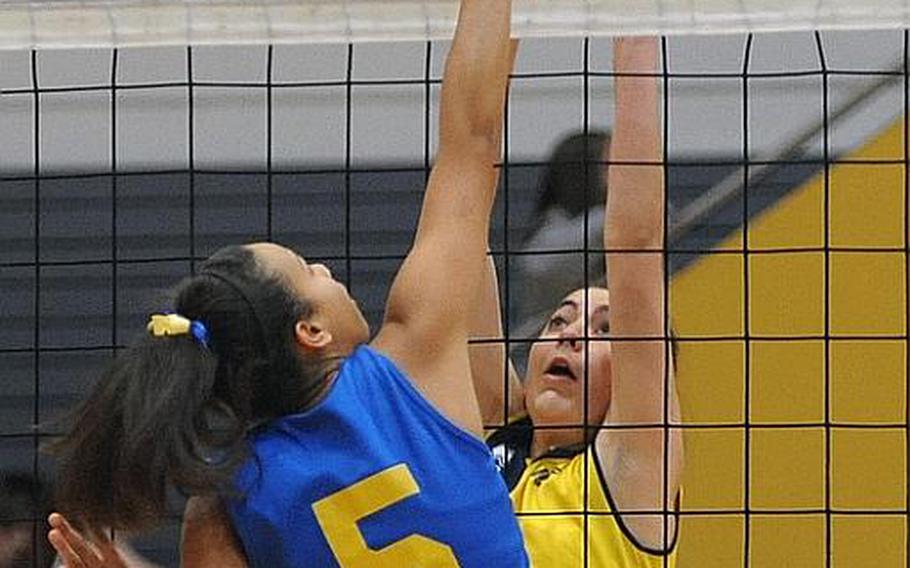 Sigonella's Deeana Brown and Florence's Alexandra Draime go against each other at the net in a Division III semifinal at the DODDS-Europe volleyball championships in Ramstein. Florence won 25-20, 25-21, 25-17 to advance to Saturday's final against Rota.