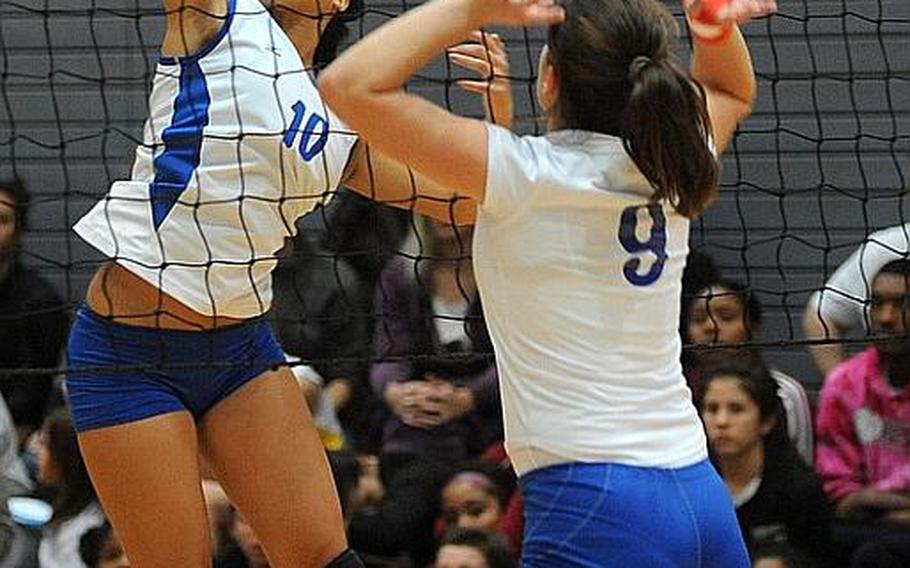 Rota's Natalia Rivera, left, slams one over the net against Ana-Marija Vasileva of Brussels in Rota's 25-10, 25-11, 25-18 semifinal win on Friday. Rota will face Florence in the Division III final at the DOODS-Europe volleyball championships.