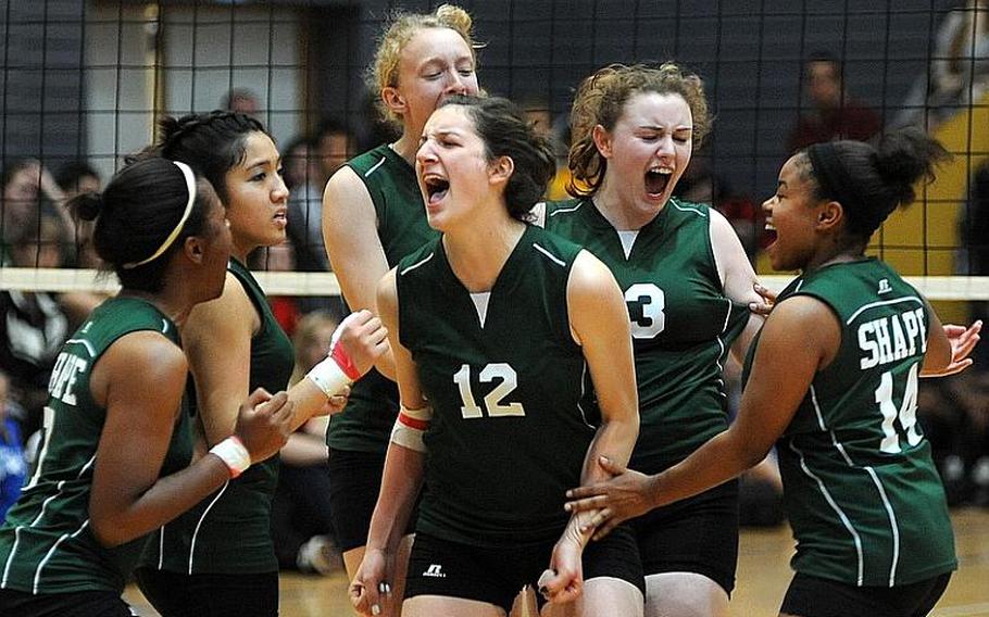 The SHAPE Spartans celebrate a big point in their 25-23, 25-20 win over Ramstein on Friday.