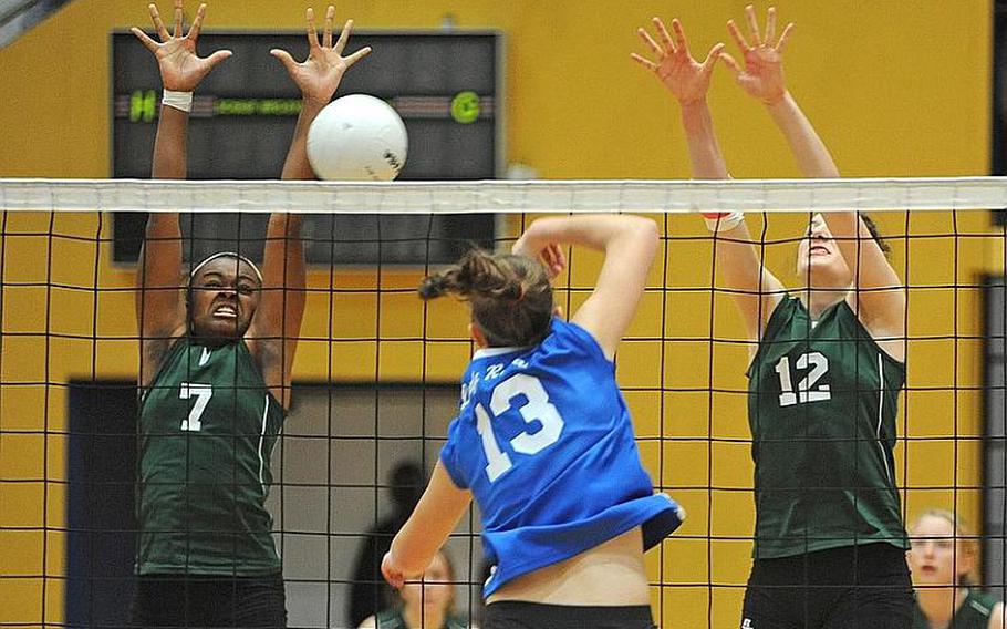 SHAPE's Paris Johnson, left, and Teresa Muldoon try to block a shot by Ramstein's Sara Szybist in Division I action on Friday. SHAPE beet the top seed 25-23, 25-20.