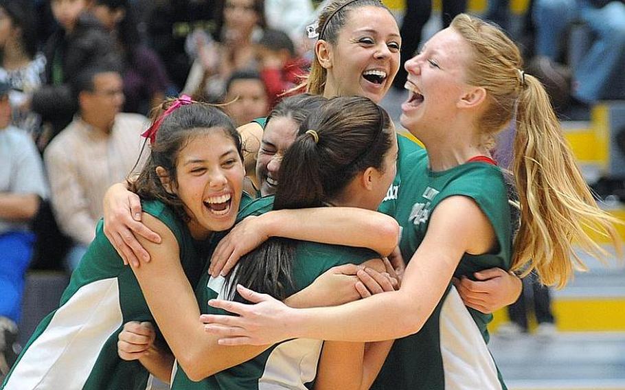 The Naples Lady Wildcats celebrate their Division II title after defeating AFNORTH 25-14, 25-12, 25-13 at the DODDS-Europe volleyball finals in Ramstein on Saturday.