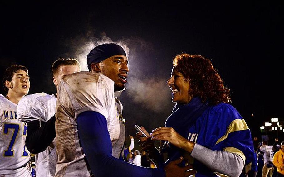 Wiesbaden's Daniel Harris is congratulated by a fan after his team won the DODDS-Europe Division I football championship Saturday night.