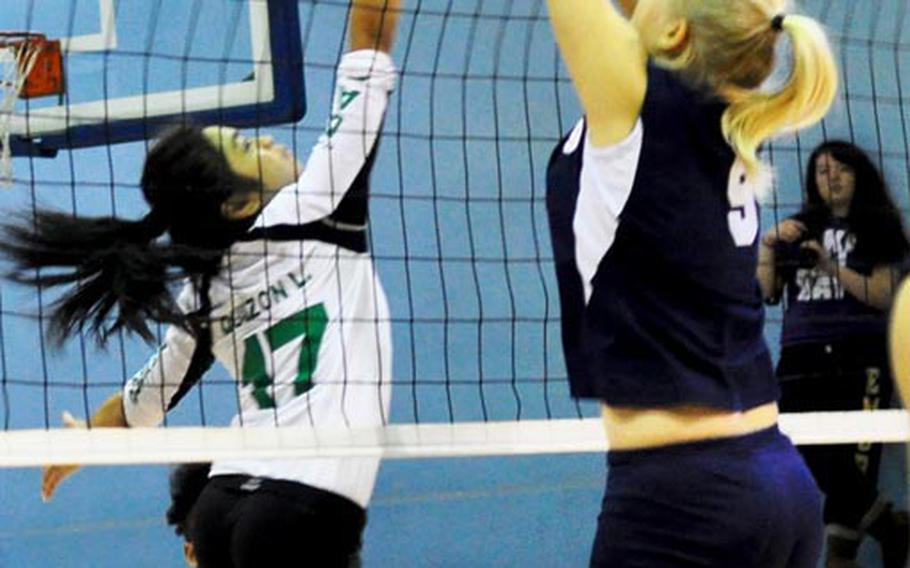 Leanne Quizon of Daegu High tries to dink a backhand shot past Morrison Academy's Ilona Heiskanen during Friday's championship match in the 2011 Far East High School Girls Division II Volleyball Tournament at Camp Walker, South Korea. Morrison won its first title since 2006 after four straight second-place finishes, beating Daegu in four sets each in a two-match final.