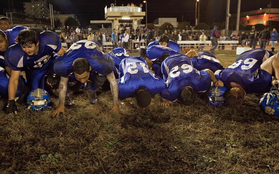 The Yokota Panthers kiss Bonk Field after winning the Far East Football Division I Championship Saturday at Yokota Air Base, Japan.