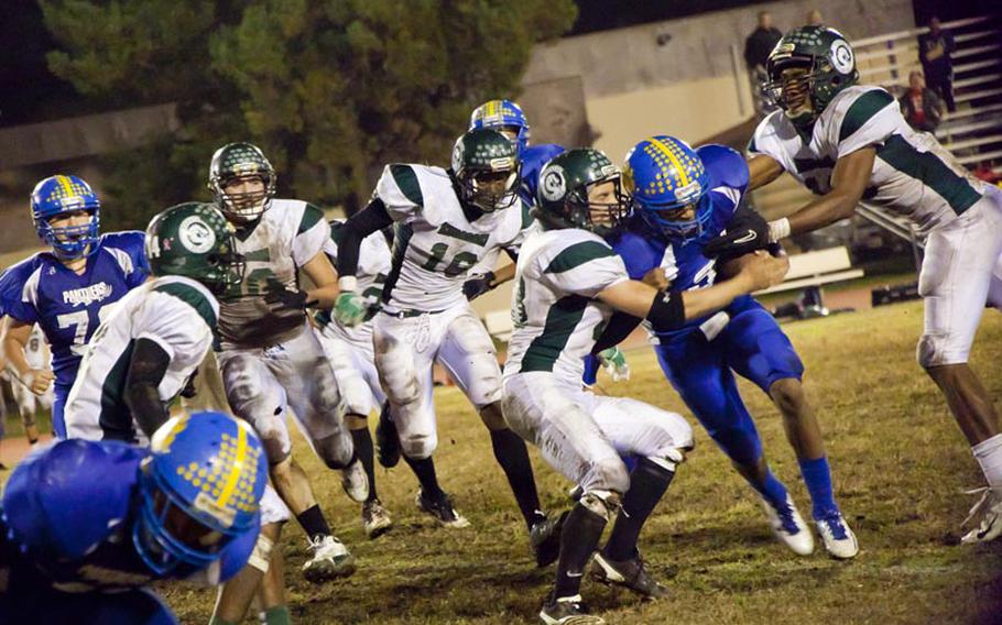 Yokota's Stanley Speed pushes through the Kubaski Dragons at the Far East Football Division I Championships Saturday at Yokota Air Base, Japan.