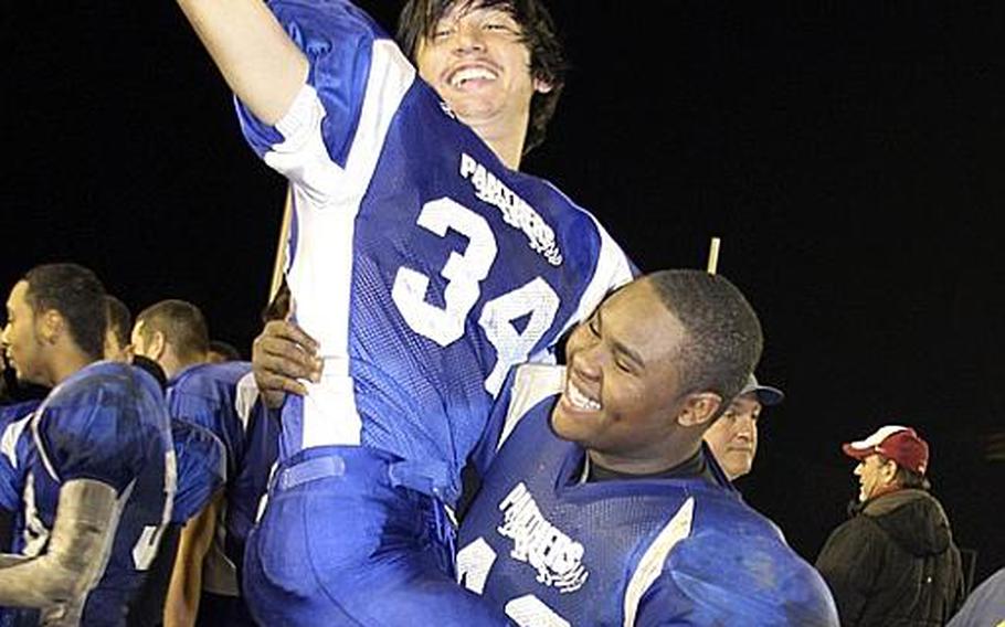 Yokota Panthers Phillip Burnett lifts receiver Jared Morgain airborne in celebration after their 34-6 victory Saturday over Kubasaki  in the Far East Division I championship game. It was Yokota's first D-I title in school history.