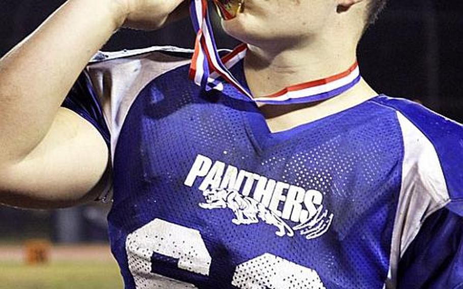 Yokota Panthers lineman Jake Jackson kisses the gold medal after their 34-6 victory Saturday over Kubasaki  in the Far East Division I championship game. It was Yokota's first D-I title in school history.