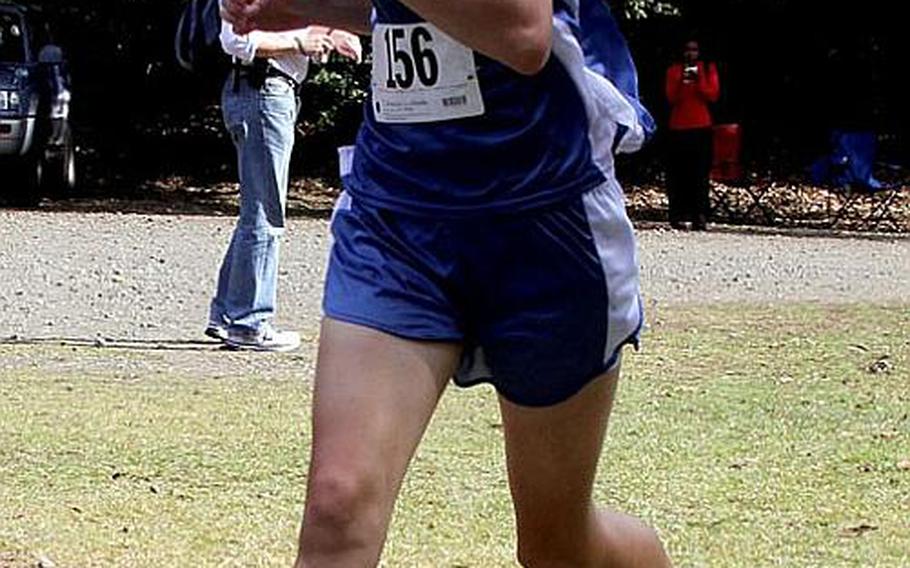 Seoul American Falcons senior Amanda Henderson crosses the finish line in 20 minutes, 55.5 seconds to capture her second straight Far East High School Cross-Country title.