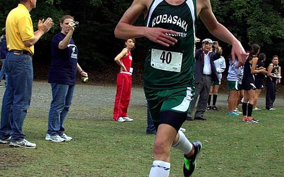 Kubasaki Dragons freshman Erik Armes crosses the finish line to win his first Far East High School Cross-Country championship in Tokyo. Armes was clocked in 17 minutes, 42.2 seconds. 