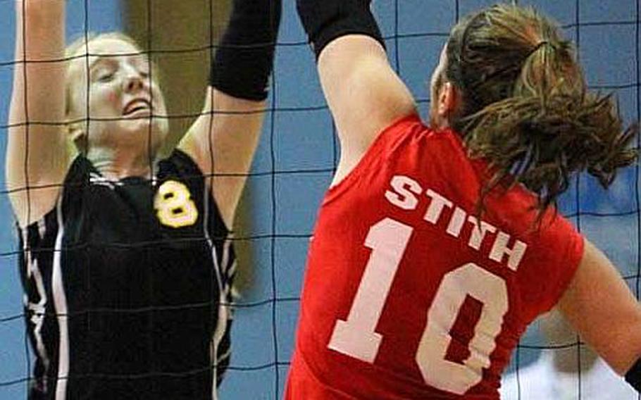 American School in Japan's Liz Thornton, left, couldn't stop everyone from spiking against her team this year, including this successful attempt by Nile C. Kinnick's Emily Stith, but she was successful at the net more times than not.
