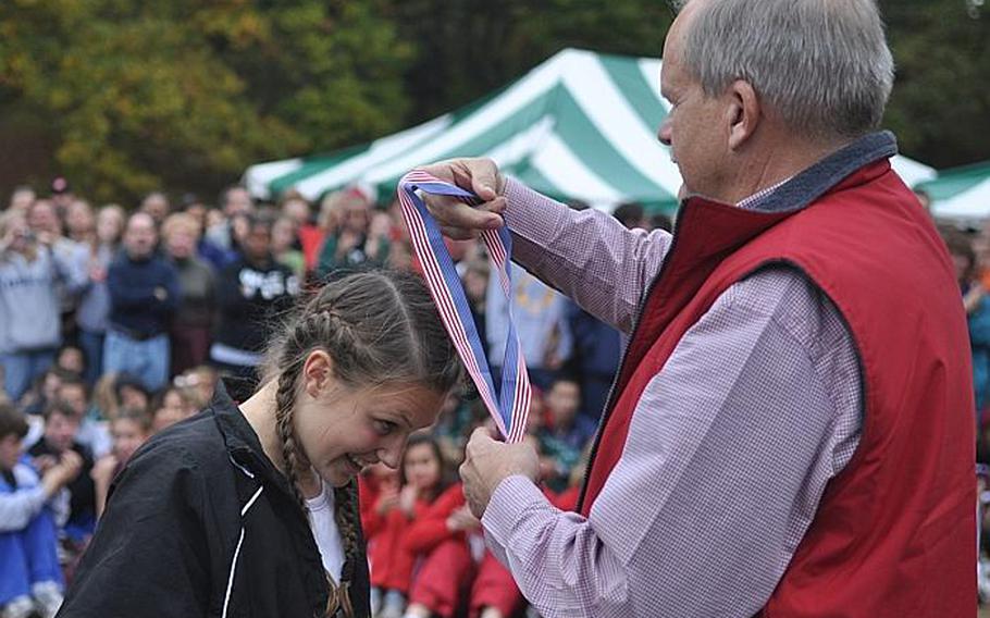 Patch sophmore Baileigh Sessions is awarded the gold medal for finishing first at the 2011 European cross country championships.