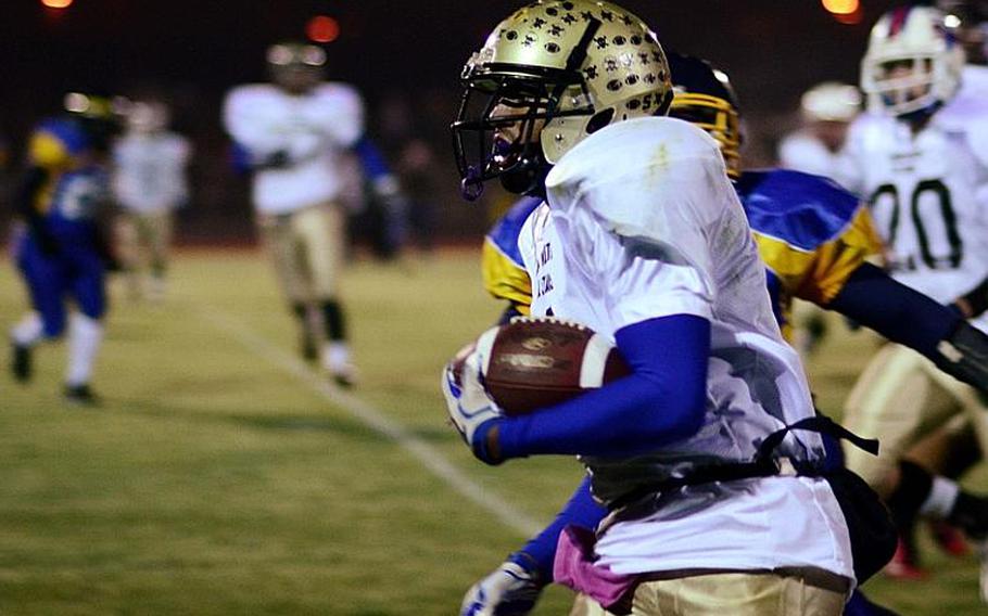 Daniel Harris of the North All Star Squad get around the corner on his way to the end zone in the DODDS-Europe high school football all star game.  Harris has been selected as the Stars and Stripes Athlete of the Year for football.