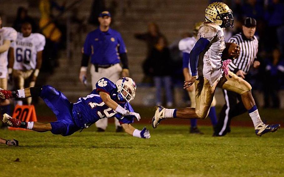 Wiesbaden's Daniel Harris avoids a tackle by Ramstein's Jaap Van Gaalen in the DODDS Division I football championship game on Nov.5.  Harris has been selected as the Stars and Stripes Athlete of the Year for football.
