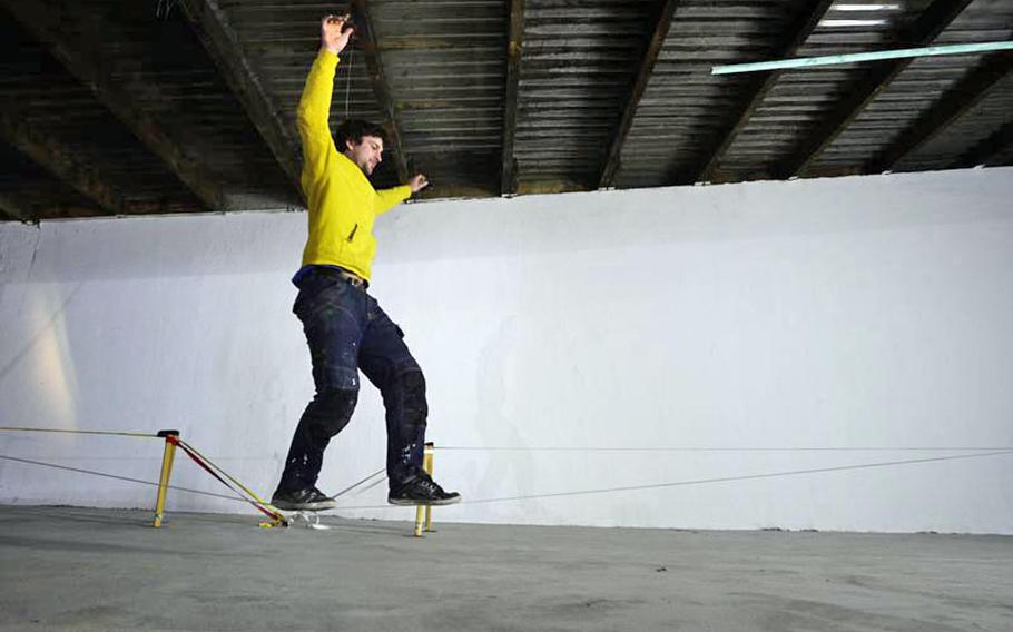 Luke Brady demonstrates "slack-lining" in RockTown's upper-level slack-lining area. There are three different lines set up for different levels of difficulty at the bouldering gym.