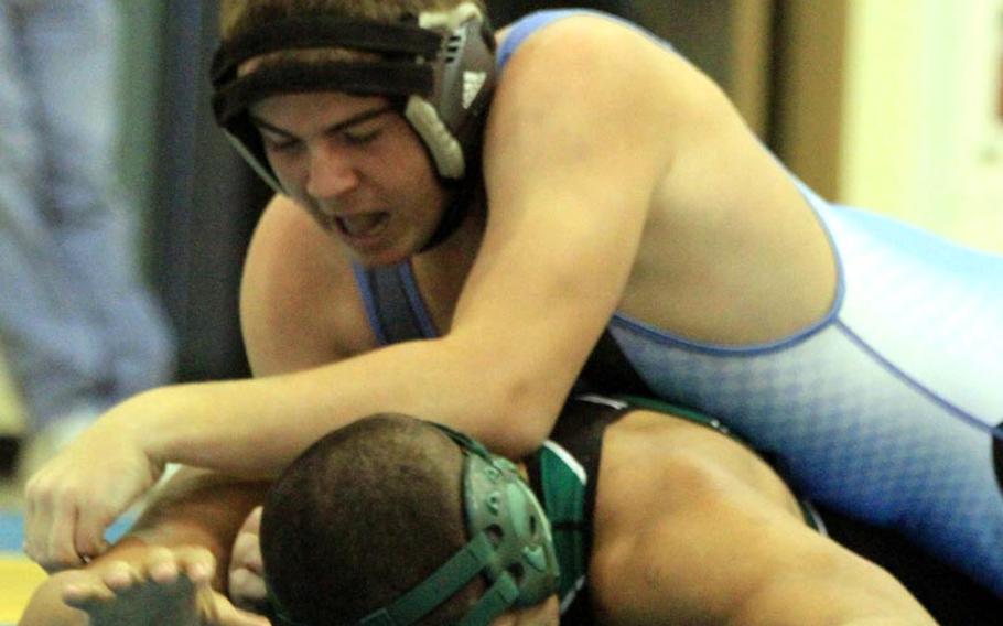 Michael McGee of Osan American gets the upper hand on Daegu's Jorge Algarin during Saturday's 180-pound bout in DODDS Korea's season-opening wrestling tri-meet at Osan American High School, Osan Air Base, South Korea. McGee won by pin and the host Cougars edged the Warriors 33-32.