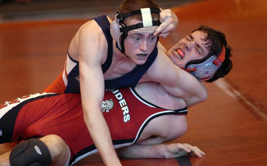 Lakenheath senior Kyle Leanhart fights for control against Kaiserslautern's Jeff Lawson, also a senior, during the season opener Saturday at RAF Lakenheath, England. Leanhart won the match in the 132-pound weight class with a pin.