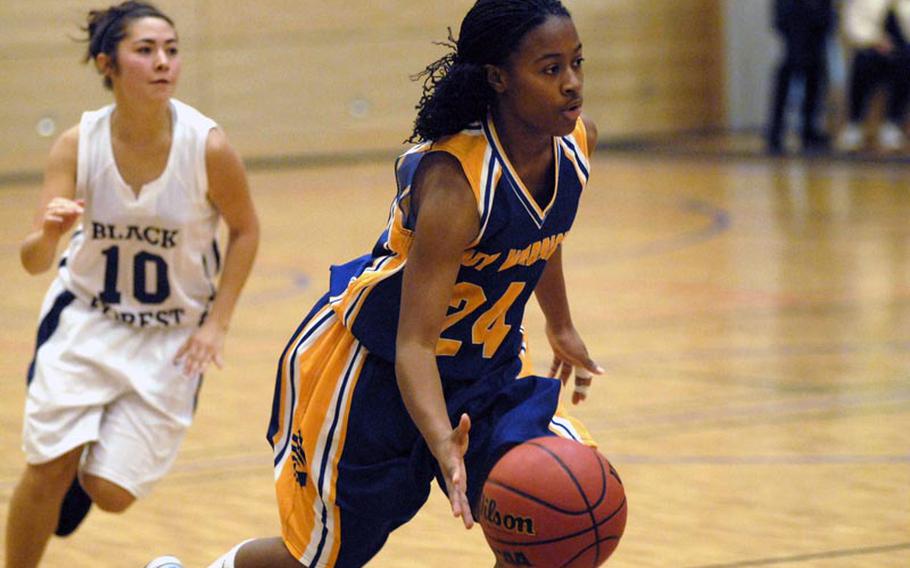 Wiesbaden sophomore Phylecia Faublas drives past Black Forest Academy senior Amy Dominguez during Saturday's Wiesbaden victory.  Faublas led all Lady Warriors scorers with nine points.