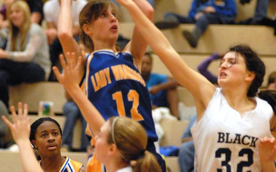 Wiesbaden junior Meghan Smith shoots over the outstretched arm of Black Forest Academy freshman Hannah Harrop during Saturday's DODDS-Europe basketball matchup.