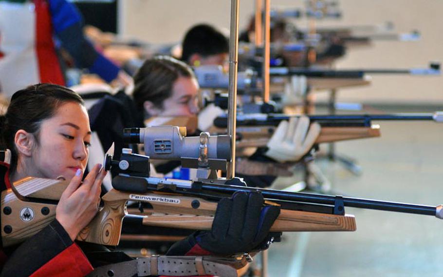 Jennifer Johnson adjusts her rifle during the first rifle meet of the season Saturday at Patch High School. Johnson tied with Madeline Hershberger for highest individual score at 274. Patch won the event with a score of 1,350.