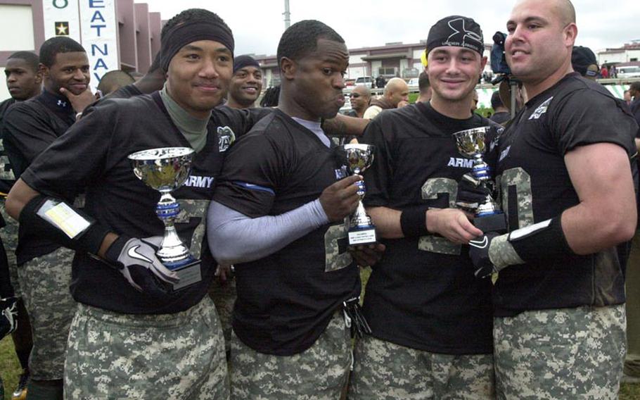 Army Most Valuable Player awardees Jamie Poole (overall MVP), Joseph Smallwood (offensive MVP) and Josh Harris and Michael Villalobos (co-defensive MVPs) celebrate with their hardware after Saturday's 22nd Okinawa Army-Navy flag football rivalry game at Torii Field, Okinawa. Army rallied from a 21-12 deficit to beat Navy 25-21.