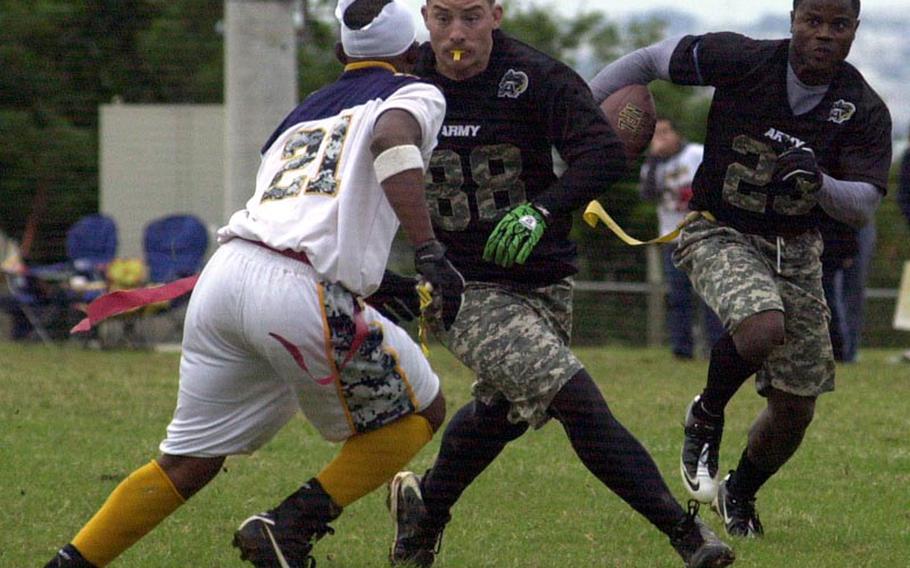 Army running back Joseph Smallwood follows the block of Steven McCleskey against Navy defender Byron Nakamura during Saturday's 22nd Okinawa Army-Navy flag football rivalry game at Torii Field, Okinawa. Army rallied from a 21-12 deficit to beat Navy 25-21.