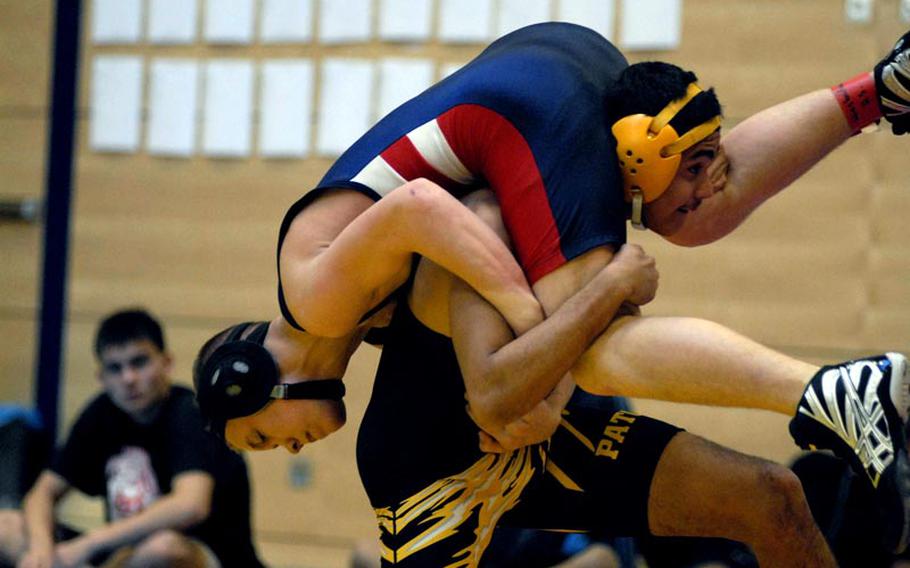 Patch senior Thomas Trevino gets Lakenheath freshman Nelson Arroyo in the air before bringing him to the mat on Saturday at a wrestling tournament at Wiesbaden High School.