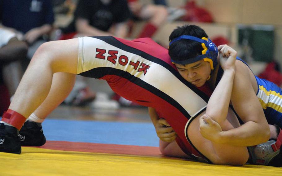 Wiesbaden freshman Hunter Lunasin tries to pin down Kaiserslautern freshman Mark Roskosky during an early round 220-pound matchup at a Wiesbaden High School hosted wrestling tournament.