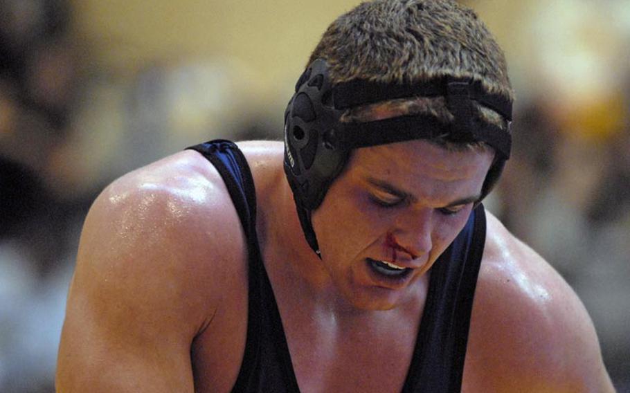 Bitburg junior Bryson Randall takes a breather while tending to his bloody nose during early round action at a wrestling tournament at Wiesbaden High School.