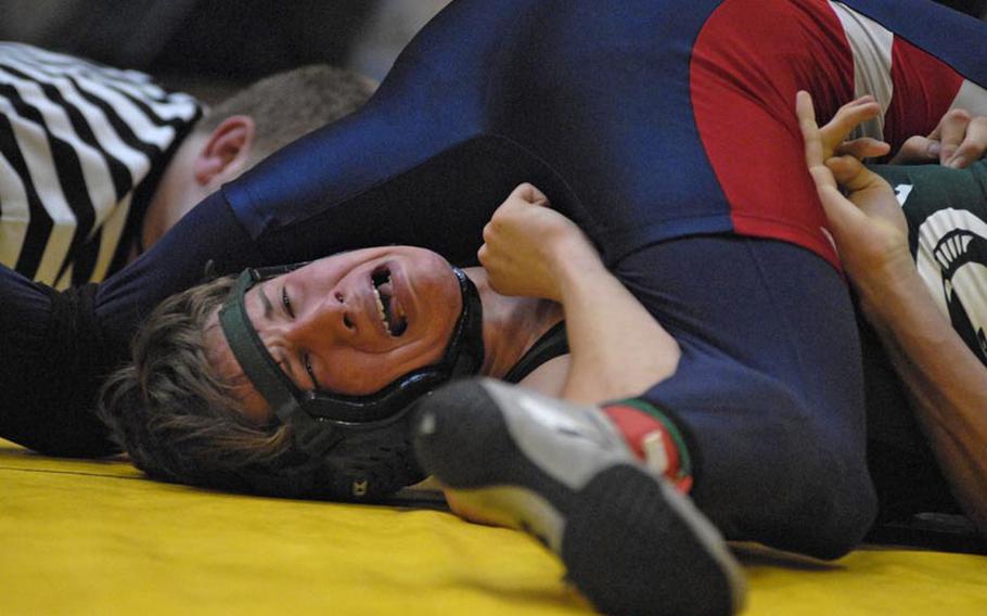 SHAPE's Jacob Stoffer tries to get out from underneath Lakenheath's Devon Parrish in a semifinal 152-pound match during a tournament at Wiesbaden High School.