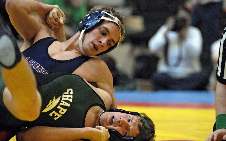 Lakenheath senior Devon Parrish works to get control early during his victory over SHAPE's Jacob Stoffer during a Saturday semifinal 152-pound match at a wrestling tournament in Wiesbaden.