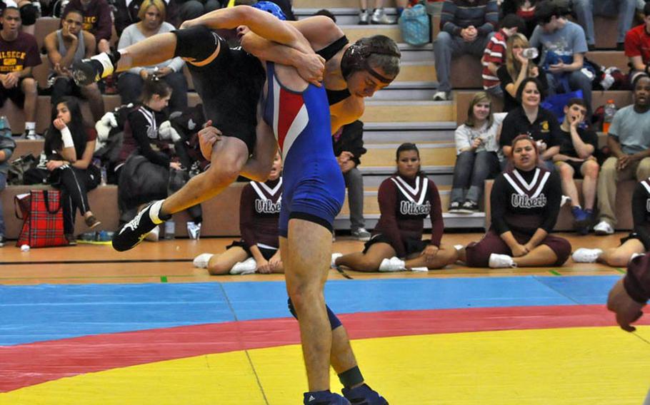 Ramstein sophomore T.J. Moore attempts to slam Jeremy Sullivan, a senior from Vilseck in a 132-ound bout. Sullivan went on to win the match by decision 16-15. 