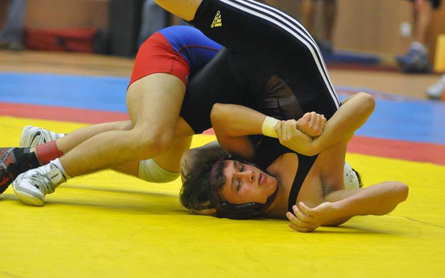 Senior Zachary Rogers of Vilseck is pinned by Ramstein's Adam Franz, also a senior,  in the championship bout of the 126-pound weight class Saturday in Vilseck, Germany. 