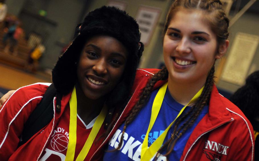 Nile C. Kinnick Red Devils senior center Emily Stith, right, took freshman guard De'Asia Brown under her wing early in the girls basketball season after the youngster wasn't accorded the warmest of receptions by her teammates.