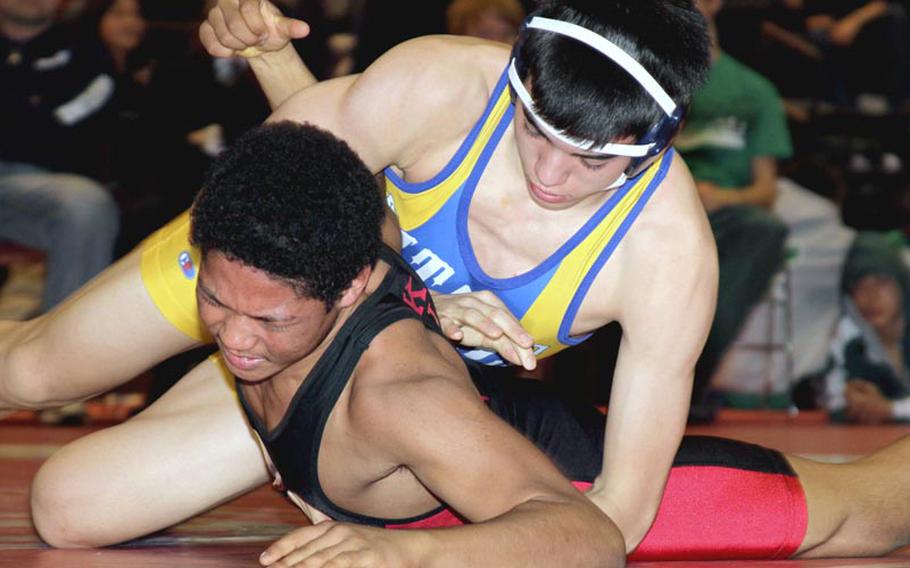 St. Mary's Internationa's Brendan Hymas, right, ties up Nile C. Kinnick's Alex Banks during Saturday's 158-pound championship bout in the Nile C. Kinnick Invitational "Beast of the Far East" Wrestling Tournament in Japan. Hymas decisioned Banks 2-0 (4-1, 5-2).