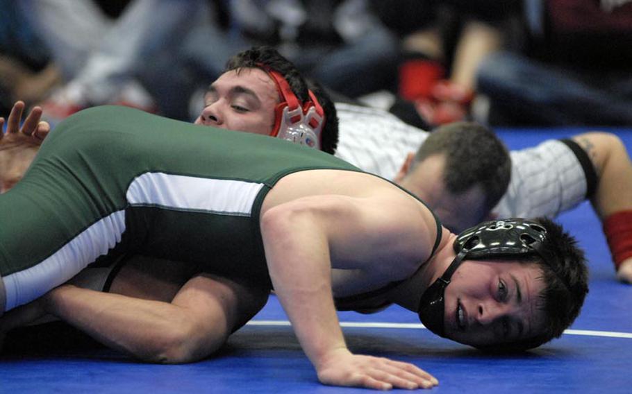 SHAPE senior Matt Lengyel tries to pin Kaiserslautern senior Jeff Lawson during a 138-pound matchup at Ramstein High School.  Lengyel went on to pin Lawson late in the match.  The Royals played host to six other DODDS-Europe wrestling teams Saturday afternoon.