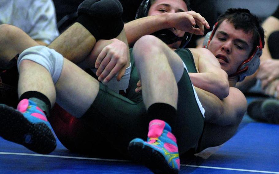 SHAPE senior Matt Lengyel tries to free himself from the grip of Kaiserslautern senior Jeff Lawson during a 138-pound matchup at Ramstein High School.  Lengyel went on to pin Lawson late in the match.  The Royals played host to six other DODDS-Europe wrestling teams Saturday afternoon.