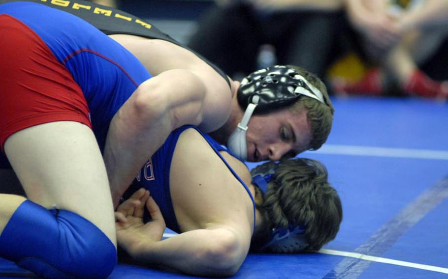 Patch senior Calen Fields tries to prevent Ramstein senior Josh McCarthy from getting up during a 170 pound wrestling match Saturday at Ramstein High School.  Fields went on to win the match and is hoping for a third straight gold medal at next month&#39;s European championships.